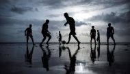 File picture of people playing football at a beach in Mumbai, June 25, 2014. REUTERS/Danish Siddiqui/Files