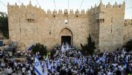 Far right Israeli supporters wave Israeli flags as they pass through the Damascus Gate in Jerusalem's Old City on May 24, 2017 to commemorate the Jerusalem Day, marking the establishment of Israeli control over the Old City following its capture in the Si