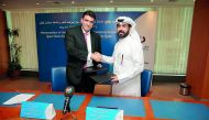 Qatar Stock Exchange CEO, Rashid bin Ali Al Mansoori (right) and Dr Ivan Ninov, Executive Dean of SUQ, after the signing ceremony.