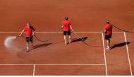 Supporting staff water the court at Roland Garros, Paris, France during a French Open final in this file photo.
