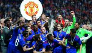 Manchester United's players and officials celebrate with the UEFA Europa League trophy after defeating Ajax Amsterdam in the final at the Friends Arena in Solna, Sweden on Wednesday.