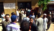 Egyptians wait outside a hospital to retreive some of the bodies of the victims of an attack, in which 28 Coptic pilgirms were gunned down following a visit to a monastery, in Idwah district of the Minya province, some 260 kms south of the capital Cairo, 