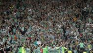 Celtic players celebrate in front of their fans after victory (Reuters / Russell Cheyne)