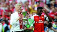 Arsenal manager Arsene Wenger and Danny Welbeck celebrate with the FA Cup trophy after defeating Chelsea in the final at Wembley Stadium in London yesterday.