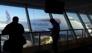 Passengers looks at a British Airway flight at John F. Kennedy (JFK) international airport in New York, on May 27, 2017. AFP / William EDWARDS