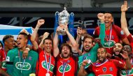 Paris Saint-Germain's Brazilian defender Maxwell (C) holds the trophy as he celebrates winning the French Cup final football match between Paris Saint-Germain (PSG) and Angers (SCO) on May 27, 2017, at the Stade de France in Saint-Denis, north of Paris. /