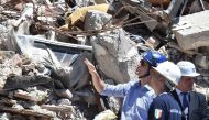 Canadian Prime Minister Justin Trudeau (L) is escorted by officials during a visit in earthquake-devastated village Amatrice, on May 28, 2017. Amatrice is part of the area affected by the earthquake that occurred in August 2016 in central Italy. (AFP / PO