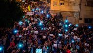 Demonstrators hold pictures of Nasser Zafzafi, leader of the Rif region's protest movement, during a demonstration against corruption, repression and unemployment in the northern city of al-Hoceima on May 30, 2017.  AFP / FADEL SENNA
