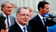France's Minister of Territorial Cohesion Richard Ferrand (C), flanked by Mayor of Deauville Philippe Augier (L), speaks to journalists in Deauville, northwestern France, on May 29, 2017. AFP / Charly Triballeau 
