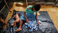 A Rohingya refugee man counts the number of biscuit packets he received as relief at the Balukhali Makeshift Refugee Camp in Cox’s Bazar, Bangladesh May 31, 2017. Reuters/Mohammad Ponir Hossain