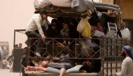 FILE PHOTO: Internally displaced people who fled Raqqa city ride a vehicle with their belongings in a camp near Ain Issa, Raqqa Governorate, Syria May 19, 2017. REUTERS/Rodi Said/File Photo