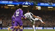Juventus' Croatian striker Mario Mandzukic shoots to score their first goal during the UEFA Champions League final football match between Juventus and Real Madrid at The Principality Stadium in Cardiff, south Wales, on June 3, 2017. (AFP / Glyn KIRK)