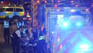 Police officers and members of the emergency services attend to a person injured in an apparent terror attack on London Bridge in central London on June 3, 2017 (AFP Photo/Daniel SORABJI).