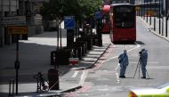 Police forensic officers work on London Bridge in London on June 4, 2017, as police continue their investigations following the June 3 terror attack.   AFP / Chris J Ratcliffe
