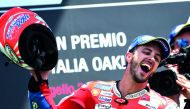 Ducati's rider Italian Andrea Dovizioso celebrates on the podium after winning the Moto GP Grand Prix at the Mugello race track, yesterday.