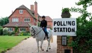 Sophie Allison, riding her horse Splash, rides out of the driveway of a private residence, set up as a Polling Station, near Reading, west of London, on June 8, 2017, as Britain holds a general election.   AFP / Adrian DENNIS
