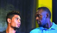 Usain Bolt of Jamaica (right) chats with Wayde Van Niekerk of South Africa during a press conference in Kingston, on Thursday.