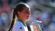 Latvia's Jelena Ostapenko celebrates with her trophy after winning her final tennis match against Romania's Simona Halep at the Roland Garros 2017 French Open on June 10, 2017 in Paris. (AFP / Eric FEFERBERG)