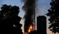 Flames and smoke billow as firefighters deal with a serious fire in a tower block at Latimer Road in West London, Britain June 14, 2017. REUTERS/Toby Melville.
