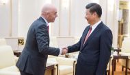 China's President Xi Jinping (R) shakes hands with FIFA President Gianni Infantino at the Great Hall of the People in Beijing on June 14, 2017. / AFP  / Fred DUFOUR
