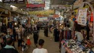 Iraqis shop at the market of Prophet Younis in eastern Mosul on June 13, 2017. / AFP / MOHAMED EL-SHAHED