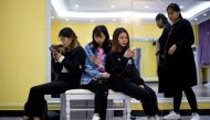This picture taken on March 14, 2017 shows students looking at their smartphones during a class at the Yiwu Industrial & Commercial College in Yiwu, east China's Zhejiang Province. AFP / Johannes EISELE 