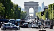 Police seal off the Champs-Elysees avenue on June 19, 2017 in Paris after a car crashed into a police van before bursting into flames, with the driver being armed, probe sources said. (AFP / ALAIN JOCARD)
