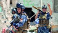An Iraqi forces member raises the victory sign as he holds a rocket-propelled grenade during the advance towards the Old City of Mosul , yesterday.

