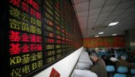 Investors look at computer screens showing stock information at a brokerage house in Shanghai, China, April 21, 2016. REUTERS/Aly Song/File Photo.
