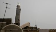 A black jihadist flag hangs from Mosul's Al-Habda minaret at the Grand Mosque, where Islamic State leader Abu Bakr al-Baghdadi declared his caliphate back in 2014, in western Mosul, Iraq May 29, 2017. REUTERS/Alkis Konstantinidis.
