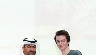 QU-CAS Dean Dr Rashid Al Kuwari presenting certificates to graduates.