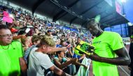 Usain Bolt of Jamaica signs  an autograph for a fan after winning the men's 100 metres event at IAAF World challenge Zlata Tretra (Golden Spike) in Ostrava, Czech Republic on Wednesday.