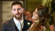 Argentine football star Lionel Messi and bride Antonella Roccuzzo pose for photographers just after their wedding at the City Centre Complex in Rosario, Santa Fe province, Argentina on June 30, 2017. AFP / EITAN ABRAMOVICH