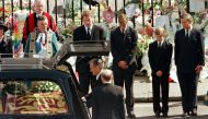 FILE PHOTO: Earl Spencer, Prince William, Prince Harry and Prince Charles watch as the coffin of Diana, Princess of Wales is placed into a hearse at Westminster Abbey following her funeral service, London, Britain September 6, 1997. REUTERS/Kieran Doherty