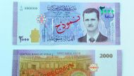 A portrait of Syria's President Bashar al-Assad is seen printed on the new Syrian 2,000-pound banknote that went into circulation on Sunday, in this handout picture provided by SANA on July 2, 2017, Syria.