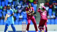 West Indies' captain Jason Holder (centre) looks on as wicketkeeper Shai Hope (right) takes a catch to dismiss India's captain Virat Kohli (left) during their fourth One Day International at the Sir Vivian Richards Cricket Ground in St. John's, Antigua, o