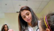A nedical student at WCM-Q examines a child during the Cornell Stars event.