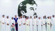Officials and other well-wishers at the UDC's installation of Tamim Al Majd mural in The Pearl-Qatar. UDC Chairman Turki bin Mohammed Al Khater (left) signing the mural.  Pic: Abdul Basit / The Peninsula