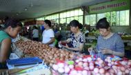 People shop for eggs at a market in Beijing. China's factory gate prices stabilised in June after slowing for three straight months.