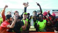 Zimbabwe cricketers pose for photographers after victory in the fifth one-day international (ODI) match against Sri Lanka at the Suriyawewa Mahinda Rajapakse International Cricket Stadium in the southern district of Hambantota, yesterday.