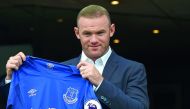 Everton's new signing, English striker Wayne Rooney poses for a photograph with his club shirt following a press conference at Goodison Park in Liverpool yesterday.