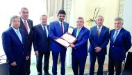 Qatar Olympic Committee (QOC) President Sheikh Joaan bin Hamad Al Thani (centre), International Olympic Committee (IOC) President Thomas Bach (third right) and the IOC Executive Board members pose for a photograph after signing an agreement yesterday. 