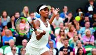 Venus Williams of the US returns against Latvia's Jelena Ostapenko during their women's singles quarter-final match at he 2017 Wimbledon Championships at The All England Lawn Tennis Club in Wimbledon, southwest London, yesterday.