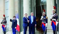 French President Emmanuel Macron greets US President Donald Trump at the Elysee Palace in Paris, yesterday.
