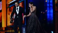 Alia Bhatt reacts after learning she got the award for Best Actress as she arrives with Varun Dhawan on stage during the IIFA Awards July 15, 2017 at the MetLife Stadium in East Rutherford, New Jersey during the 18th International Indian Film Academy (IIF