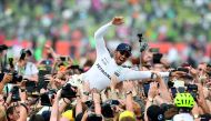 Mercedes’ British driver Lewis Hamilton celebrates with fans after he won the British Formula One Grand Prix at the Silverstone motor racing circuit in Silverstone, central England.