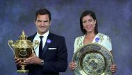 A handout composite picture taken on July 16, 2017 shows 2017 Wimbledon Men's and Women's singles champions, Switzerland's Roger Federer (L) and Spain's Garbine Muguruza posing with their trophies at the Champions Dinner in central London. AFP Photo / Ael