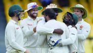 Zimbabwe cricketer Hamilton Masakadza (third left) celebrates with after dismissing Sri Lankan captain Dinesh Chandimal during the fourth day of a one-off Test match at the R Premadasa Cricket Stadium in Colombo.