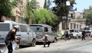 People inspect the site after an attack with a bomb-laden vehicle near the Al Majd hospital in Idlib, Syria on July 16, 2017. (Ahmed Momar - Anadolu Agency)