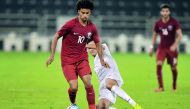 Qatar’s Akram Afif (left) vies for the ball possession with a Turkmenistan player during their 2018 AFC U-23 Championship Group C qualifier at  Al Sadd Stadium yesterday. Qatar beat Turkmenistan 2-0. Picture by Kammutty VP /  The Peninsula
